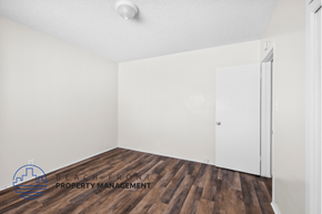 Gardena apartment for rent - a bedroom with white walls and wood flooring and a closet
