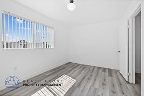 Van Nuys apartment for rent - a living room with white walls and wood floors and a window