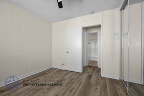 Long Beach apartment for rent - a bedroom with white walls and wood flooring and a closet