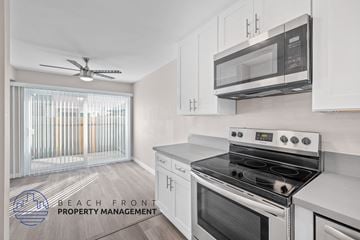 Redondo Beach apartment for rent - A kitchen with a stove top oven and microwave above it.