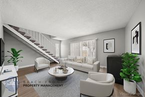 Hawthorne apartment for rent - A living room with a staircase and a couch.