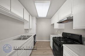 Los Angeles apartment for rent - a kitchen with white cabinets and a stove and a sink