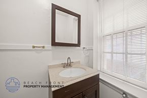 Los Angeles apartment for rent - A bathroom with a sink, mirror, and window with blinds.