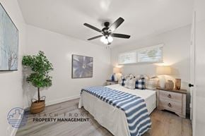 Anaheim apartment for rent - A bedroom with a bed, a ceiling fan, and a potted plant.