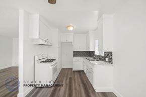 Inglewood apartment for rent - A kitchen with white cabinets and a wooden floor.