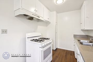 Long Beach apartment for rent - A kitchen with a white stove and cabinets.