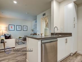 Los Angeles apartment for rent - A modern kitchen with a stainless steel dishwasher and white cabinets.