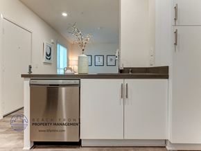 Los Angeles apartment for rent - A modern kitchen with a stainless steel dishwasher and white cabinets.