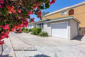 Long Beach apartment for rent - a home with a white garage door and a driveway