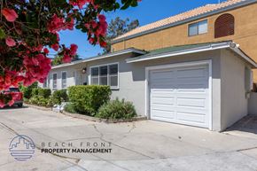 Long Beach apartment for rent - a home with a white garage door in front of it