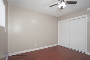 Hawthorne apartment for rent - A room with a ceiling fan and a white closet door.