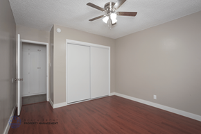Hawthorne apartment for rent - A room with a ceiling fan and a door leading to another room.