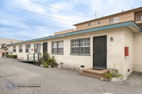 Hawthorne apartment for rent - A building with a red door and a sign that says Beach Front Property Management.