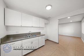 Cudahy apartment for rent - an empty kitchen with white cabinets and a sink