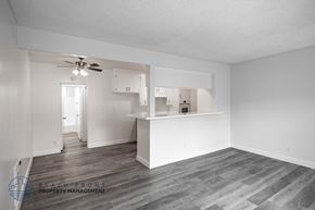 Long Beach apartment for rent - A spacious room with a kitchenette and a ceiling fan.
