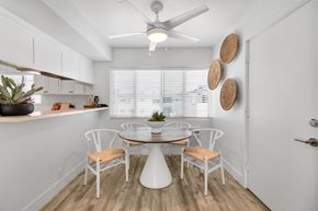 Newport Beach apartment for rent - A white dining room with a table and chairs.