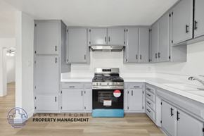 La Habra apartment for rent - A kitchen with a stove top oven and cabinets.
