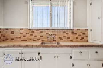 Long Beach apartment for rent - A kitchen with a sink and a window with blinds.