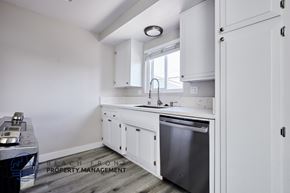 Redondo Beach apartment for rent - A kitchen with white cabinets and a stainless steel dishwasher.
