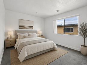 Westminster apartment for rent - A bedroom with a large bed, two nightstands, and a potted plant.