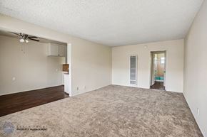 Gardena apartment for rent - A spacious room with a carpeted floor and a ceiling fan.