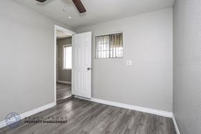 Downey apartment for rent - A room with a door and a window with blinds.
