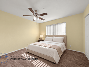 Hawthorne apartment for rent - A bedroom with a bed, carpet, and a ceiling fan.