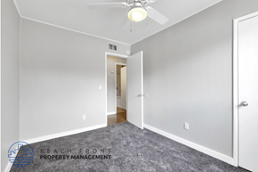 Costa Mesa apartment for rent - a bedroom with a carpeted floor and a ceiling fan