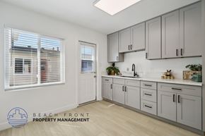 Buena Park apartment for rent - A kitchen with a logo for Beach Front Property Management.