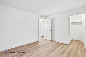 Los Angeles apartment for rent - A white room with wooden floors and two doors.