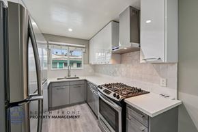 Los Angeles apartment for rent - A modern kitchen with a stove top oven and a refrigerator.