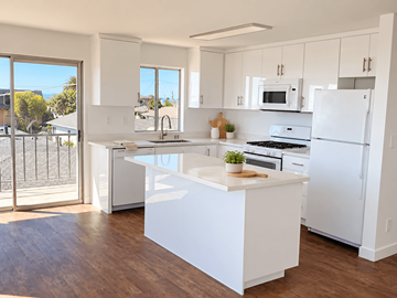 San Pedro apartment for rent - A white kitchen with a large island in the middle.