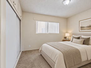 Wilmington apartment for rent - A bedroom with a large bed and a painting on the wall.
