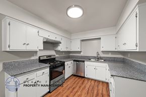 Stanton apartment for rent - A kitchen with white cabinets and a granite countertop.
