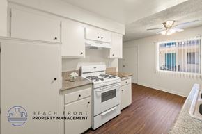 Paramount apartment for rent - A kitchen with white appliances and cabinets.
