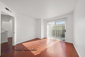 Santa Monica apartment for rent - A room with wooden floors and white walls, with a window covered by a white blind.