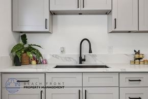 Buena Park apartment for rent - A kitchen with a marble countertop and a sink.