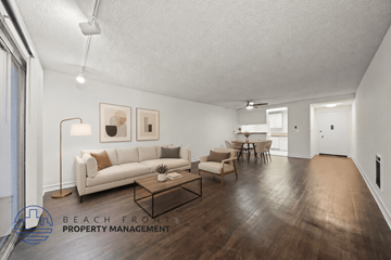 Redondo Beach apartment for rent - A living room with a white couch, a coffee table, and a dining table with chairs.