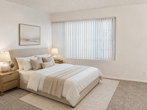 Lawndale apartment for rent - A bedroom with a large bed and two lamps on nightstands.