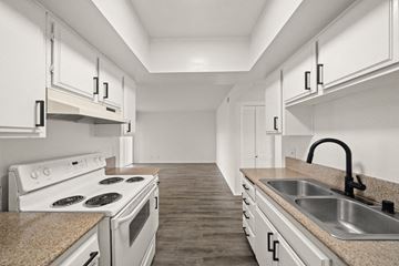 Long Beach apartment for rent - a kitchen with white appliances and white cabinets