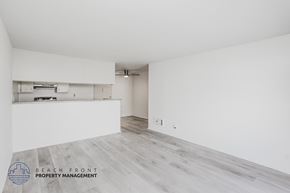 Long Beach apartment for rent - A spacious room with a logo for Beach Front Property Management in the bottom left corner.