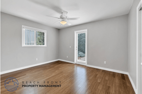 Costa Mesa apartment for rent - an empty living room with wood flooring and a ceiling fan