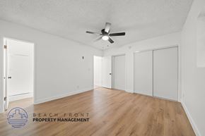 Redondo Beach apartment for rent - A spacious room with a ceiling fan and wooden flooring.