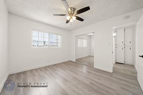 Gardena apartment for rent - A spacious room with a ceiling fan and wooden flooring.