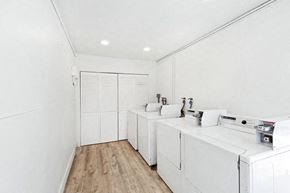 Newport Beach apartment for rent - A white bathroom with a sink and a toilet.