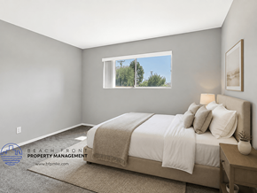 Brea apartment for rent - A well-lit bedroom with a large bed and a window showing a view of the outdoors.