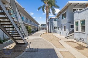 Long Beach apartment for rent - a group of buildings with stairs and a palm tree