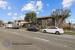 Whittier apartment for rent - Cars parked on a street in front of a building with the logo