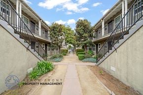 Long Beach apartment for rent - A row of apartment buildings with a walkway between them.