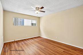 Redondo Beach apartment for rent - A room with a ceiling fan and wooden flooring.